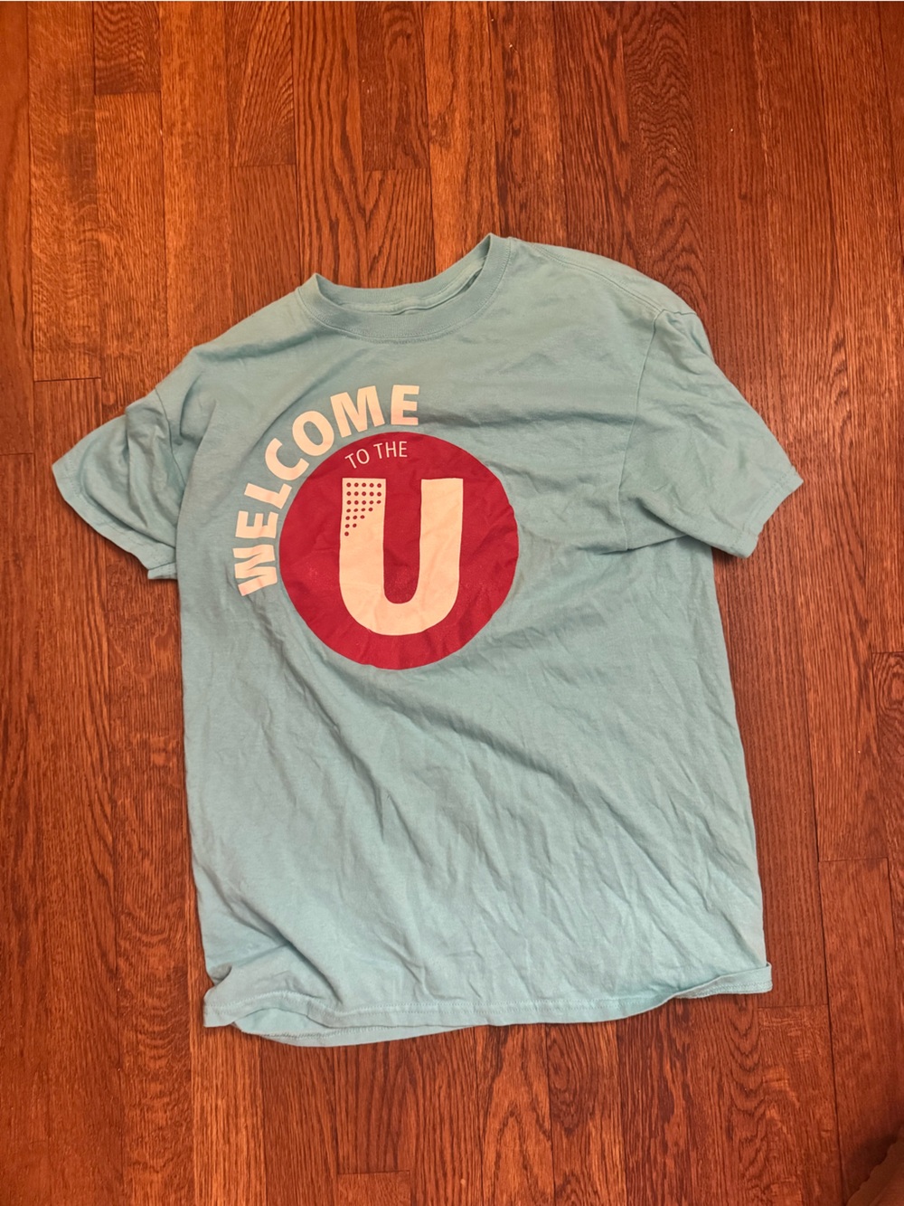 Light Blue Graphic Tee with Red Circle 'Welcome To The U' Print